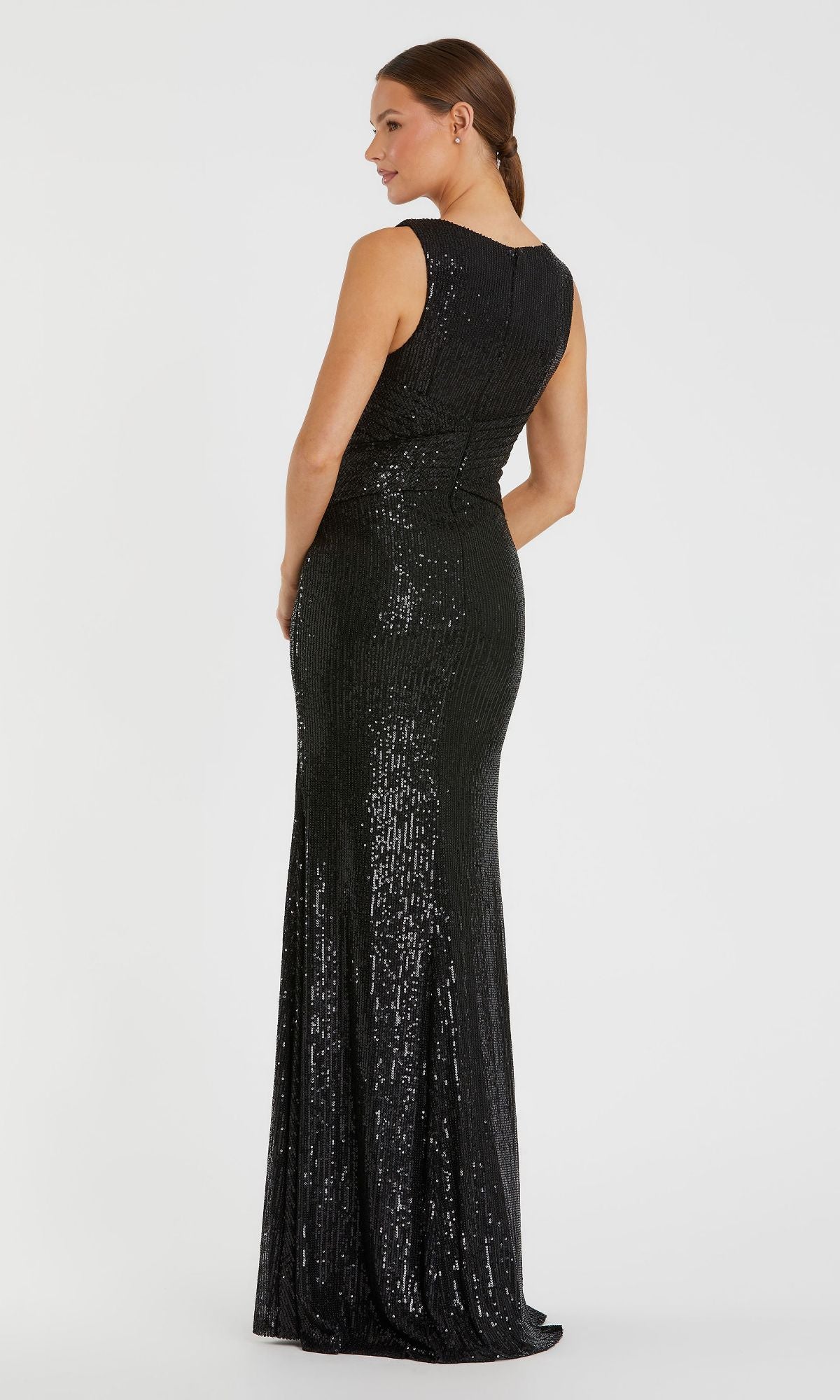 A woman models the Mac Duggal 26598, a sleeveless long formal dress, standing with her back to the camera and head turned to the side against a plain white background.